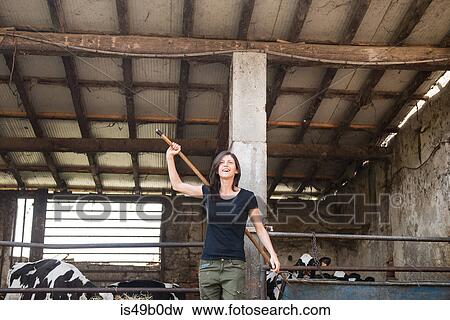 Female organic farmer with pitch fork over her shoulder on dairy farm View Large Photo Image Stock Photo - Female organic farmer with pitch fork over her shoulder on dairy farm. Fotosearch