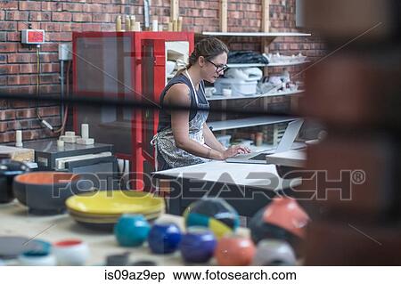 Female potter checking online orders in workshop View Large Photo Image Stock Photography - Female potter checking online orders in workshop. Fotosearch