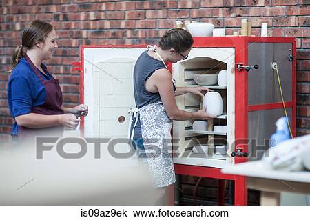 Female potter putting vase into workshop kiln View Large Photo Image Stock Image - Female potter putting vase into workshop kiln. Fotosearch