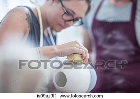 Female potter smoothing surface on vase in workshop View Large Photo Image Stock Image - Female potter smoothing surface on vase in workshop. Fotosearch