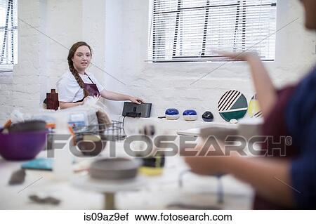 Female potters chatting in workshop View Large Photo Image Stock Image - Female potters chatting in workshop. Fotosearch