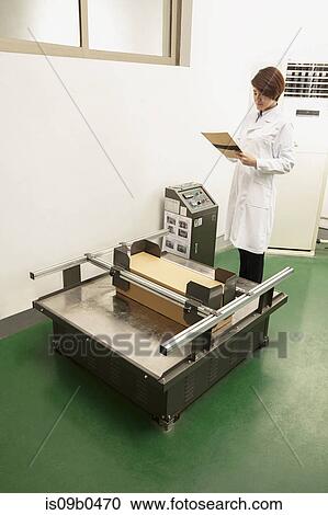Female technician reading paperwork by packaging machine in printing and packaging factory, China View Large Photo Image Stock Image - Female technician reading paperwork by packaging machine in printing and packaging factory, China. Fotosearch