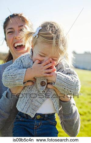 Female toddler being held up by laughing mother View Large Photo Image Picture - Female toddler being held up by laughing mother. Fotosearch