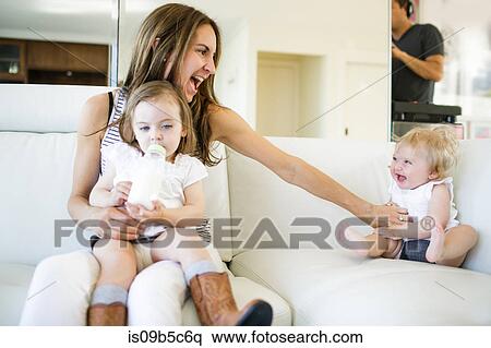 Female toddler on mother's lap drinking from baby bottle View Large Photo Image Stock Photography - Female toddler on mother's lap drinking from baby bottle. Fotosearch