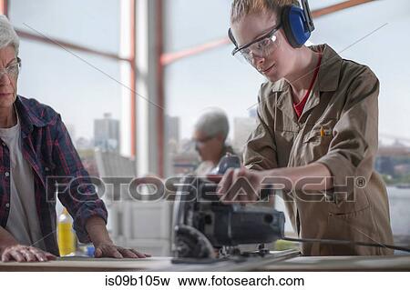 Female trainee carpenter learning to use power saw in furniture making workshop View Large Photo Image Stock Photo - Female trainee carpenter learning to use power saw in furniture making workshop. Fotosearch