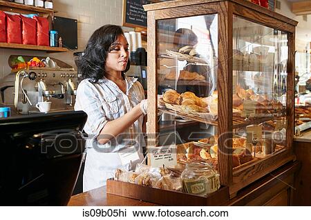 Female worker in bakery, putting fresh pasties into display cabinet View Large Photo Image Stock Image - Female worker in bakery, putting fresh pasties into display cabinet. Fotosearch