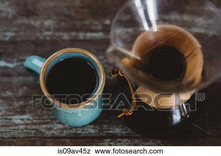 Filter coffee maker and mug of coffee, overhead view View Large Photo Image Stock Photo - Filter coffee maker and mug of coffee, overhead view. Fotosearch