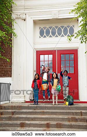 Four boys and girls jumping at elementary school entrance View Large Photo Image Stock Image - Four boys and girls jumping at elementary school entrance. Fotosearch