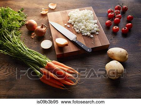 Fresh carrots, potatoes and cherry tomatoes with onions chopped on cutting board View Large Photo Image Stock Photography - Fresh carrots, potatoes and cherry tomatoes with onions chopped on cutting board. Fotosearch