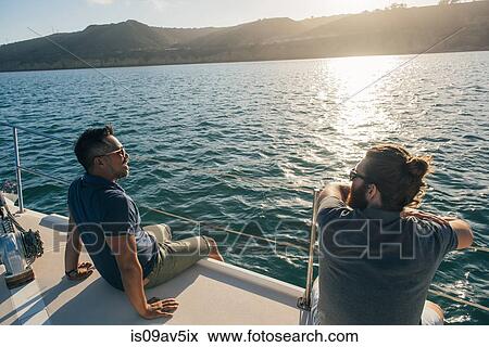 Stock Photo - Friends enjoying view on sailboat, San Diego Bay, California, USA. Fotosearch