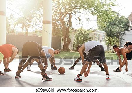 Friends on basketball court in a circle bending forwards warming up View Large Photo Image Stock Image - Friends on basketball court in a circle bending forwards warming up. Fotosearch