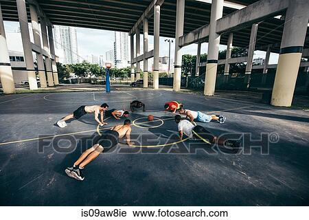 Friends on basketball court in a circle doing push ups View Large Photo Image Stock Image - Friends on basketball court in a circle doing push ups. Fotosearch