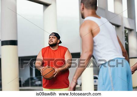 Stock Image - Friends playing basketball. Fotosearch