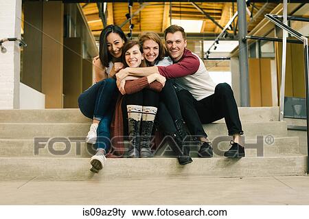 Friends sitting on steps hugging View Large Photo Image Stock Photo - Friends sitting on steps hugging. Fotosearch
