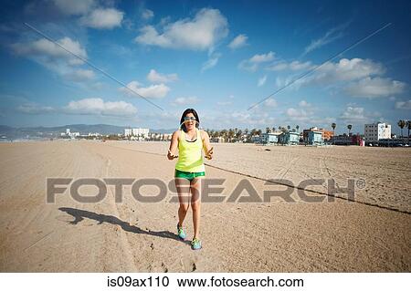 Full length front view of woman on beach catching bubble View Large Photo Image Stock Image - Full length front view of woman on beach catching bubble. Fotosearch