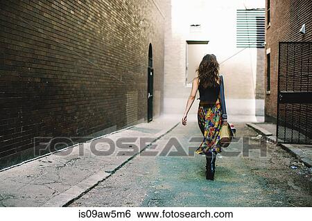 Full length rear view of woman walking down alley, Boston, Massachusetts, USA View Large Photo Image Stock Photograph - Full length rear view of woman walking down alley, Boston, Massachusetts, USA. Fotosearch