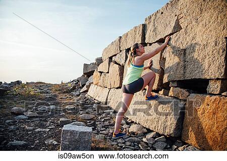 Full length side view woman climbing rocks View Large Photo Image Picture - Full length side view woman climbing rocks. Fotosearch