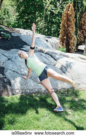 Full length view of woman doing side push up against rock View Large Photo Image Stock Photo - Full length view of woman doing side push up against rock. Fotosearch