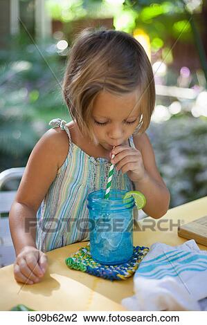 Girl drinking ice water through straw View Large Photo Image Stock Image - Girl drinking ice water through straw. Fotosearch