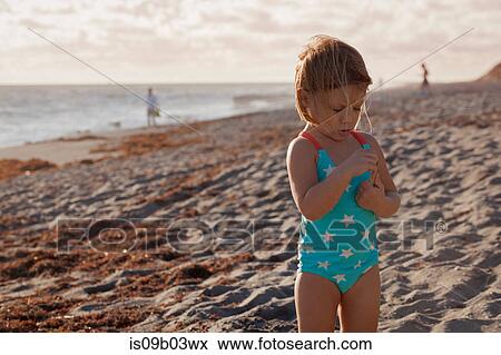 Girl examining stick on beach, Blowing Rocks Preserve, Jupiter Island, Florida, USA View Large Photo Image Stock Photo - Girl examining stick on beach, Blowing Rocks Preserve, Jupiter Island, Florida, USA. Fotosearch