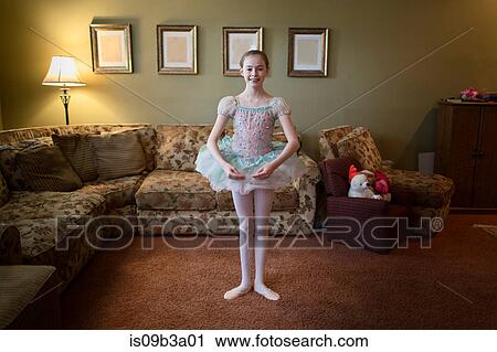 Stock Image - Girl in living room ballet dancing. Fotosearch