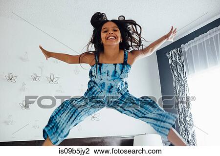 Girl jumping in mid air smiling View Large Photo Image Stock Image - Girl jumping in mid air smiling. Fotosearch