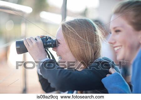 Girl looking through binoculars on tourist boat trip, Cape Town, South Africa View Large Photo Image Stock Photography - Girl looking through binoculars on tourist boat trip, Cape Town, South Africa. Fotosearch