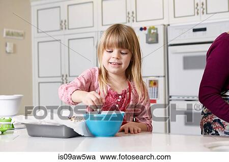 Girl mixing cake at kitchen counter View Large Photo Image Stock Image - Girl mixing cake at kitchen counter. Fotosearch