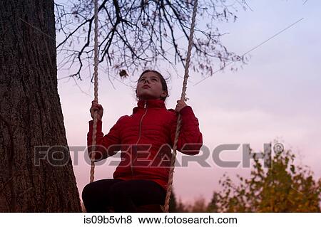Stock Photo - Girl on swing in park, Chusovoy, Russia. Fotosearch