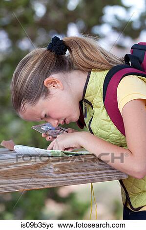 Girl peering at map with magnifier, Sedona, Arizona, USA View Large Photo Image Stock Image - Girl peering at map with magnifier, Sedona, Arizona, USA. Fotosearch