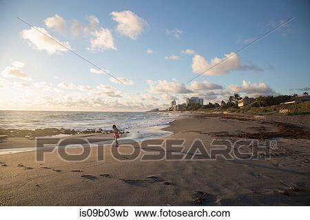Girl playing on beach, Blowing Rocks Preserve, Jupiter Island, Florida, USA View Large Photo Image Stock Image - Girl playing on beach, Blowing Rocks Preserve, Jupiter Island, Florida, USA. Fotosearch