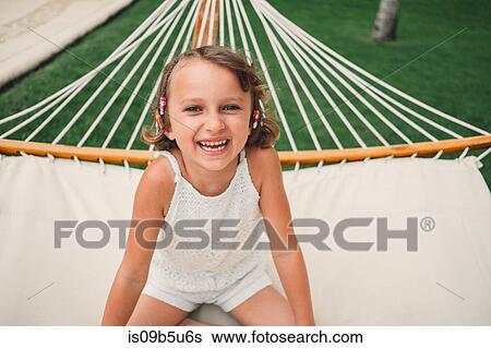 Girl smiling in hammock View Large Photo Image Stock Photograph - Girl smiling in hammock. Fotosearch