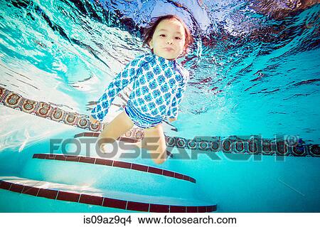 Picture - Girl underwater in swimming pool. Fotosearch