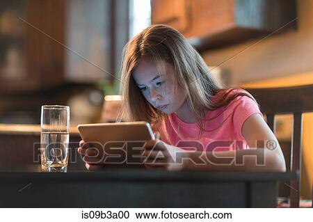 Stock Image - Girl using digital tablet. Fotosearch