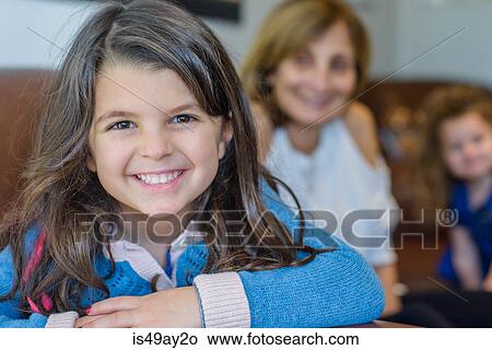 Girl with family in living room View Large Photo Image Picture - Girl with family in living room. Fotosearch