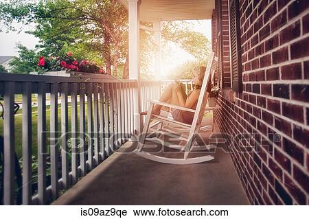Girls on porch in rocking chair using digital tablet View Large Photo Image Stock Image - Girls on porch in rocking chair using digital tablet. Fotosearch