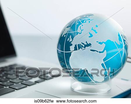 Globe and laptop on desk View Large Photo Image Stock Photo - Globe and laptop on desk. Fotosearch
