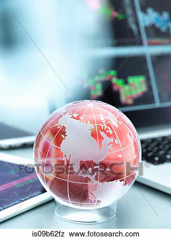 Globe with digital tablet and laptop showing international business trade View Large Photo Image Stock Photo - Globe with digital tablet and laptop showing international business trade. Fotosearch