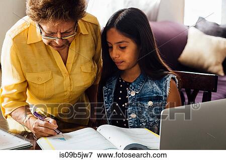 Grandmother helping granddaughter with homework View Large Photo Image Stock Photo - Grandmother helping granddaughter with homework. Fotosearch
