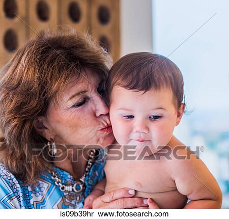 Grandmother kissing grandson's cheek View Large Photo Image Stock Photography - Grandmother kissing grandson's cheek. Fotosearch