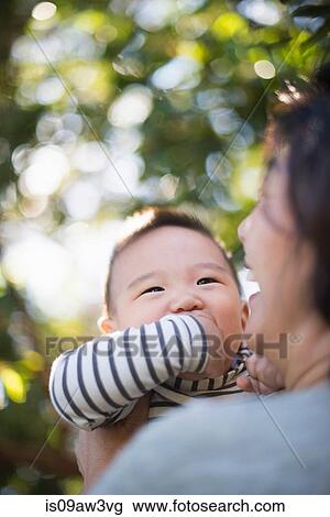 Grandmother playing with grandson outdoors View Large Photo Image Stock Image - Grandmother playing with grandson outdoors. Fotosearch