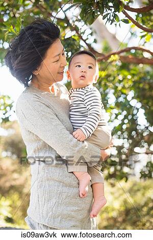 Grandmother taking walk with grandson outdoors View Large Photo Image Stock Image - Grandmother taking walk with grandson outdoors. Fotosearch