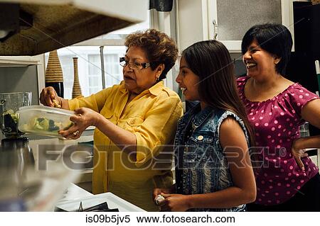 Grandmother teaching granddaughter to cook View Large Photo Image Stock Photography - Grandmother teaching granddaughter to cook. Fotosearch