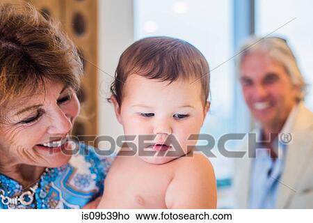 Picture - Grandparents playing with grandson. Fotosearch