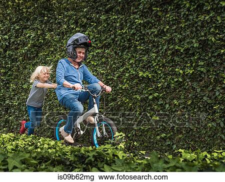 Grandson pushing grandmother on his bicycle View Large Photo Image Stock Image - Grandson pushing grandmother on his bicycle. Fotosearch