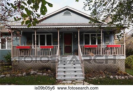 Grey country cottage style home facade with veranda in autumn, Quebec, Canada View Large Photo Image Stock Photograph - Grey country cottage style home facade with veranda in autumn, Quebec, Canada. Fotosearch