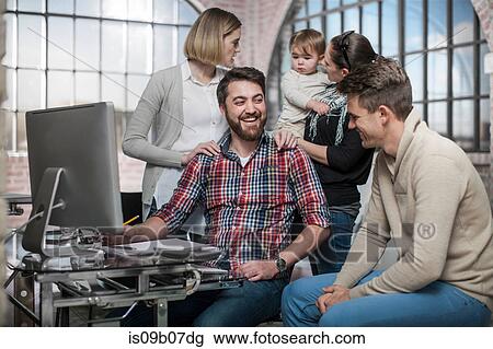 Group of adults sitting around computer having discussion, woman holding toddler behind them View Large Photo Image Stock Image - Group of adults sitting around computer having discussion, woman holding toddler behind them. Fotosearch