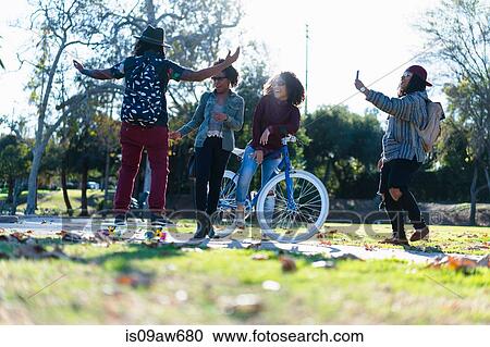 Group of female friends fooling around in park View Large Photo Image Stock Image - Group of female friends fooling around in park. Fotosearch