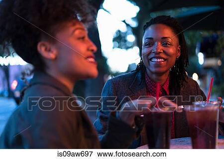 Group of female friends, having drinks at cafe, outdoors View Large Photo Image Stock Photo - Group of female friends, having drinks at cafe, outdoors. Fotosearch