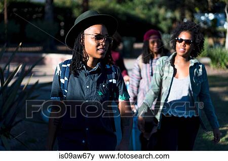 Group of female friends walking together outdoors View Large Photo Image Stock Photo - Group of female friends walking together outdoors. Fotosearch